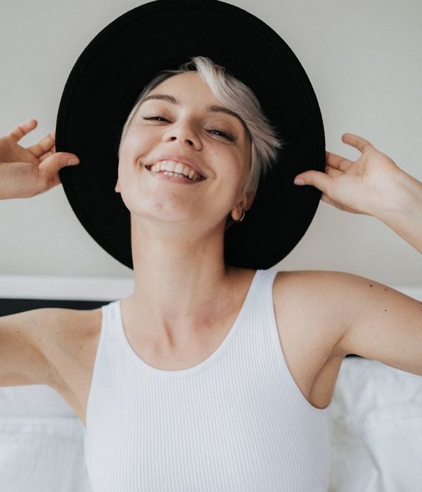 Woman feeling energized and full of life in a bright room.
